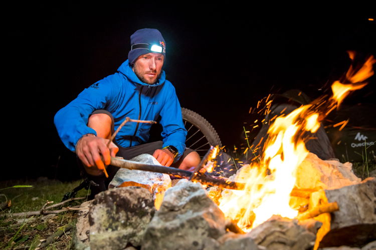 Christophe Akiki/Red Bull Content Pool - Kenny Belaey lights camping fire during filming Border to Border in Ammouaa, Lebanon