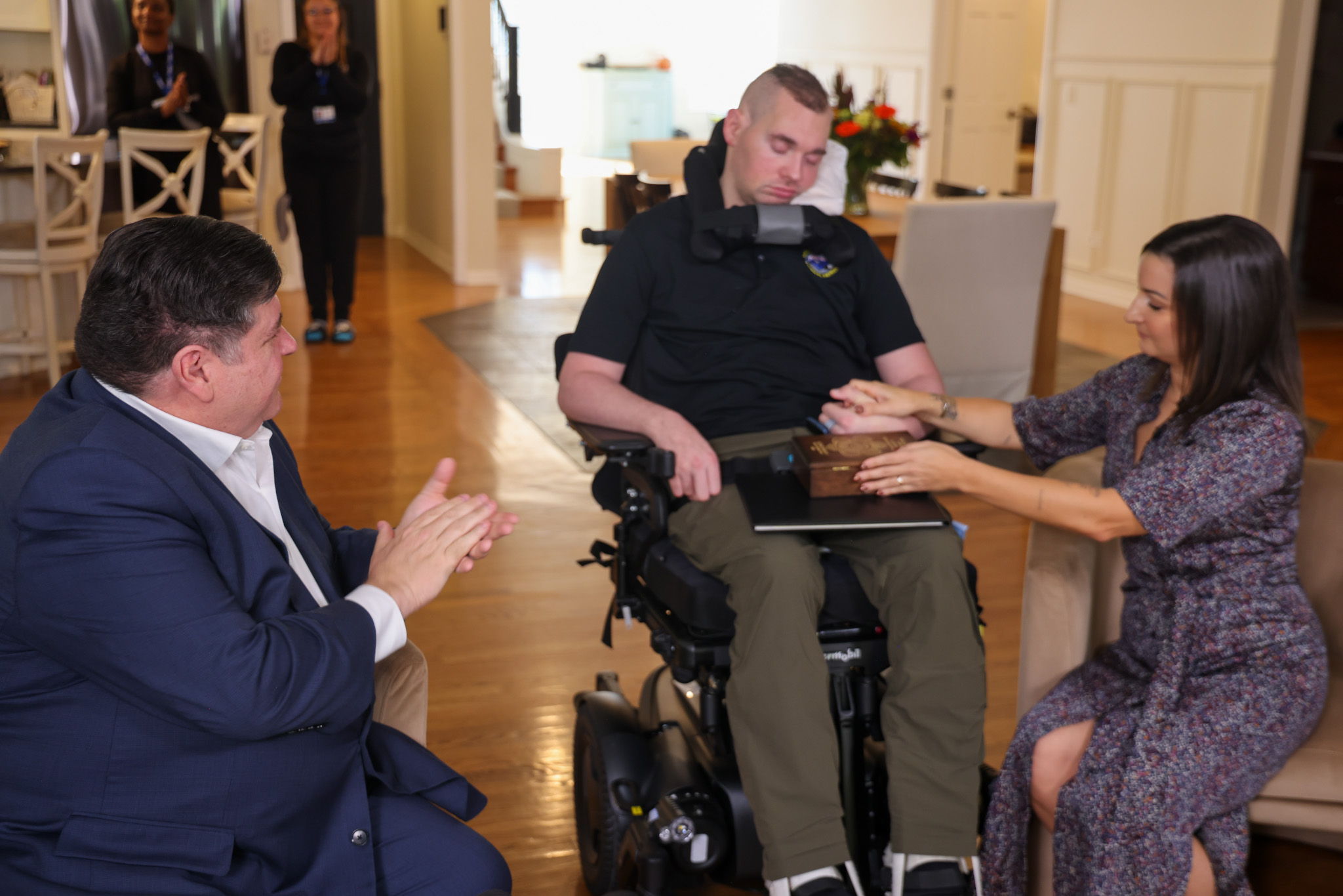 Governor Pritzker awards Illinois Law Enforcement Medal of Honor to ISP Trooper Brian Frank with his wife Lauren Frank at his side.