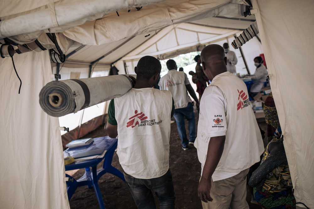 MSF team arranges the tents of the mobile clinic where the medical consultations take place in Rumangabo, in North Kivu province, eastern Democratic Republic of Congo. MSF has set up a mobile clinic in Rumangabo, where nearly 15,000 conflict-displaced people have just arrived. The front line between the Congolese army and the M23 armed group is just a few miles from the village. Photographer: Alexis Huguet