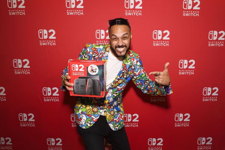 In this photo provided by Nintendo of Canada, an excited fan poses with their new Nintendo Switch 2 system
