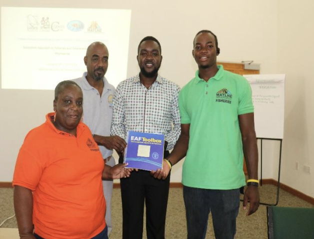 Representatives of the Fisheries and Ocean Resources Unit in Montserrat receive a copy of the EAF toolkit