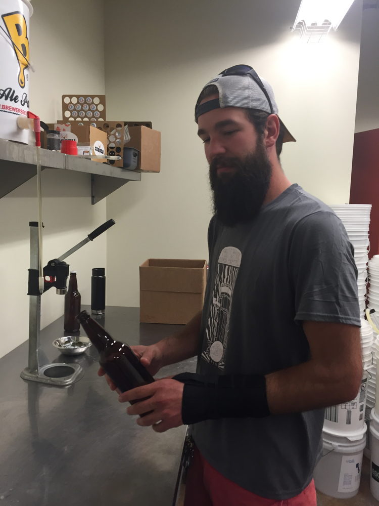 William Brant of CO-Brew bottles the beer