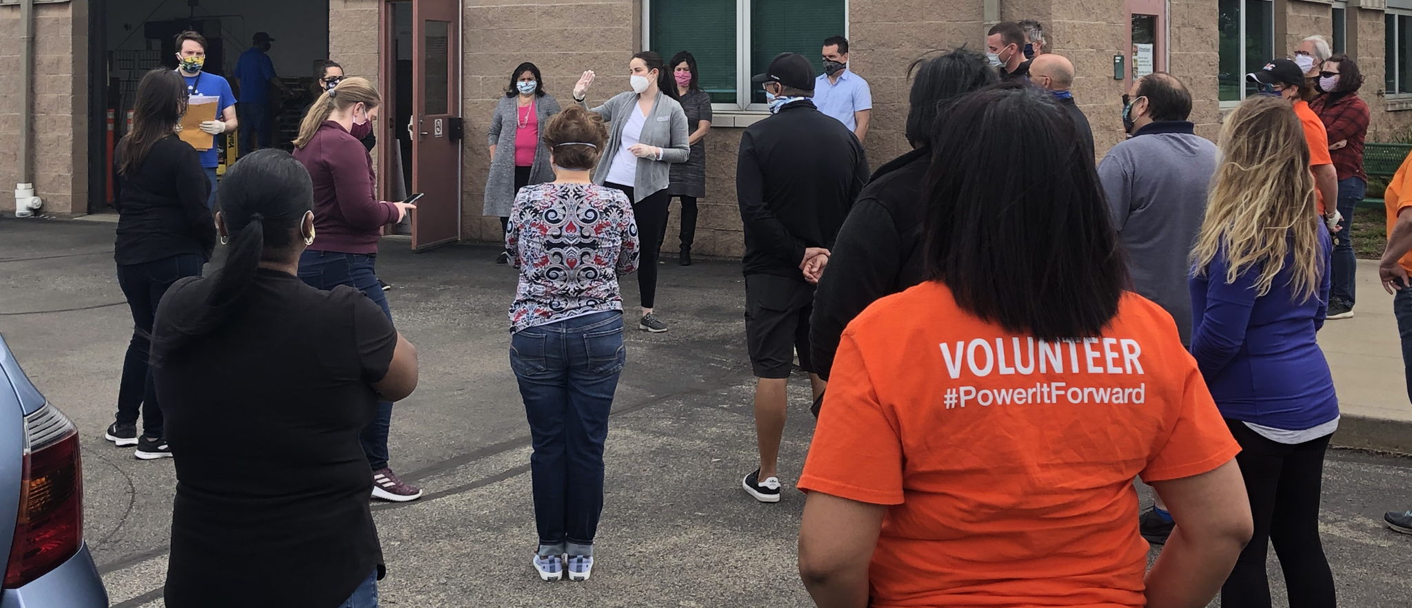 Food Bank officials welcome DLC employees to the volunteer event.