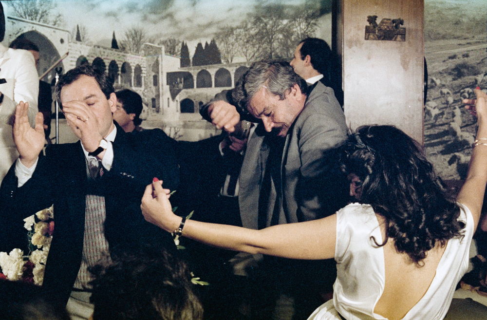 People dancing during a performance by Ahmad Doughan at a local venue. Photographed by Assaad Jradi in 1984 in Lebanon. Chromogenic process negative on cellulose acetate film, 35mm. 0287jr06792, 0287jr – Assaad Jradi collection, courtesy of the Arab Image Foundation, Beirut.