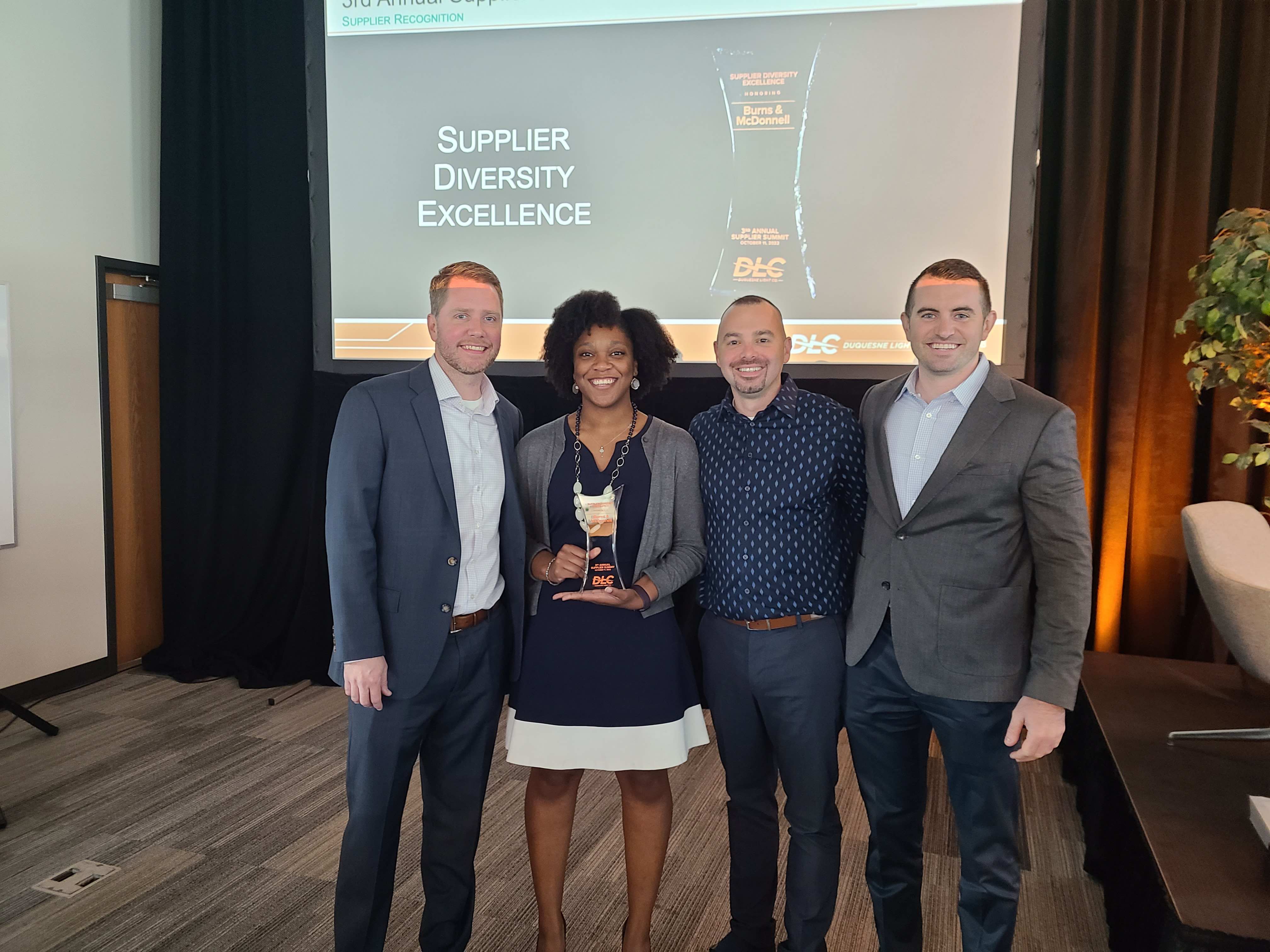 DLC Supplier Diversity Program Manager Micah Caporali (second from right) pictured with representatives from Burns & McDonnell, which won the award for Supplier Diversity Excellence.