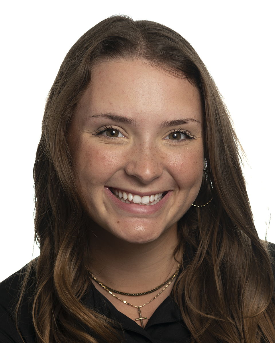 A student smiles and poses.