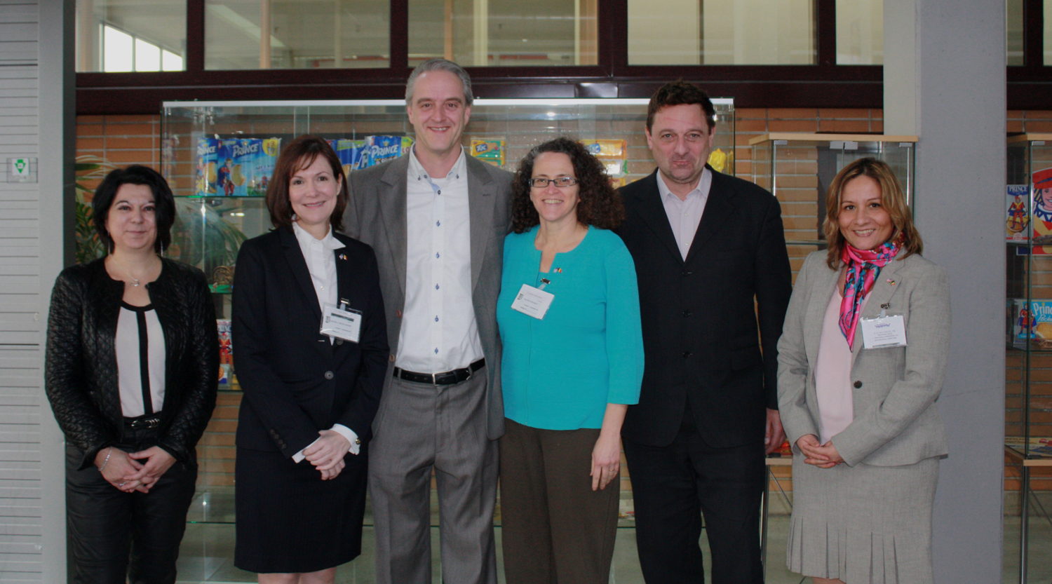 The visiting delegation posing together with the hosts in front of the entrance of the factory in Herentals (left to right): Marie-Pascale Sire, Denise Campbell Bauer, Paul Meuwes, Michele van-Rijn, Franz Kraus and Marcela Rondon.
