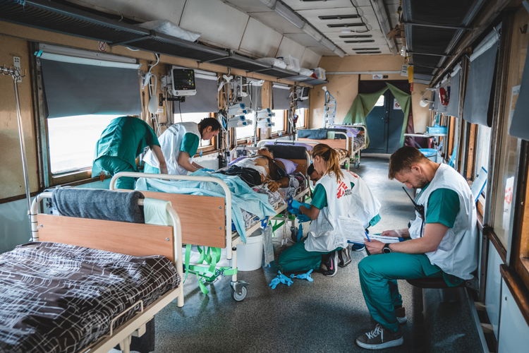 Unique Identifier Code / URN: MSB127237 Title: Doctors on Rails - MSF Medicalised train in Ukraine Copyright: Andrii Ovod Countries: Ukraine Date taken / Date Recorded: 20 May, 2022 Caption / Description: The medical team inside the intensive care unit (ICU) of the MSF medical train monitor and stabalise a seriously war-wounded patient during the journey from Pokvrosk, eastern Ukraine to Lviv, in western Ukraine. The journey takes approximately 20 hours. Since 31 March, we have transported more than 600 patients. Unique Identifier Code / URN: MSB127237 Title: Doctors on Rails - MSF Medicalised train in Ukraine Copyright: Andrii Ovod Countries: Ukraine Date taken / Date Recorded: 20 May, 2022 Caption / Description: The medical team inside the intensive care unit (ICU) of the MSF medical train monitor and stabalise a seriously war-wounded patient during the journey from Pokvrosk, eastern Ukraine to Lviv, in western Ukraine. The journey takes approximately 20 hours. Since 31 March, we have transported more than 600 patients.