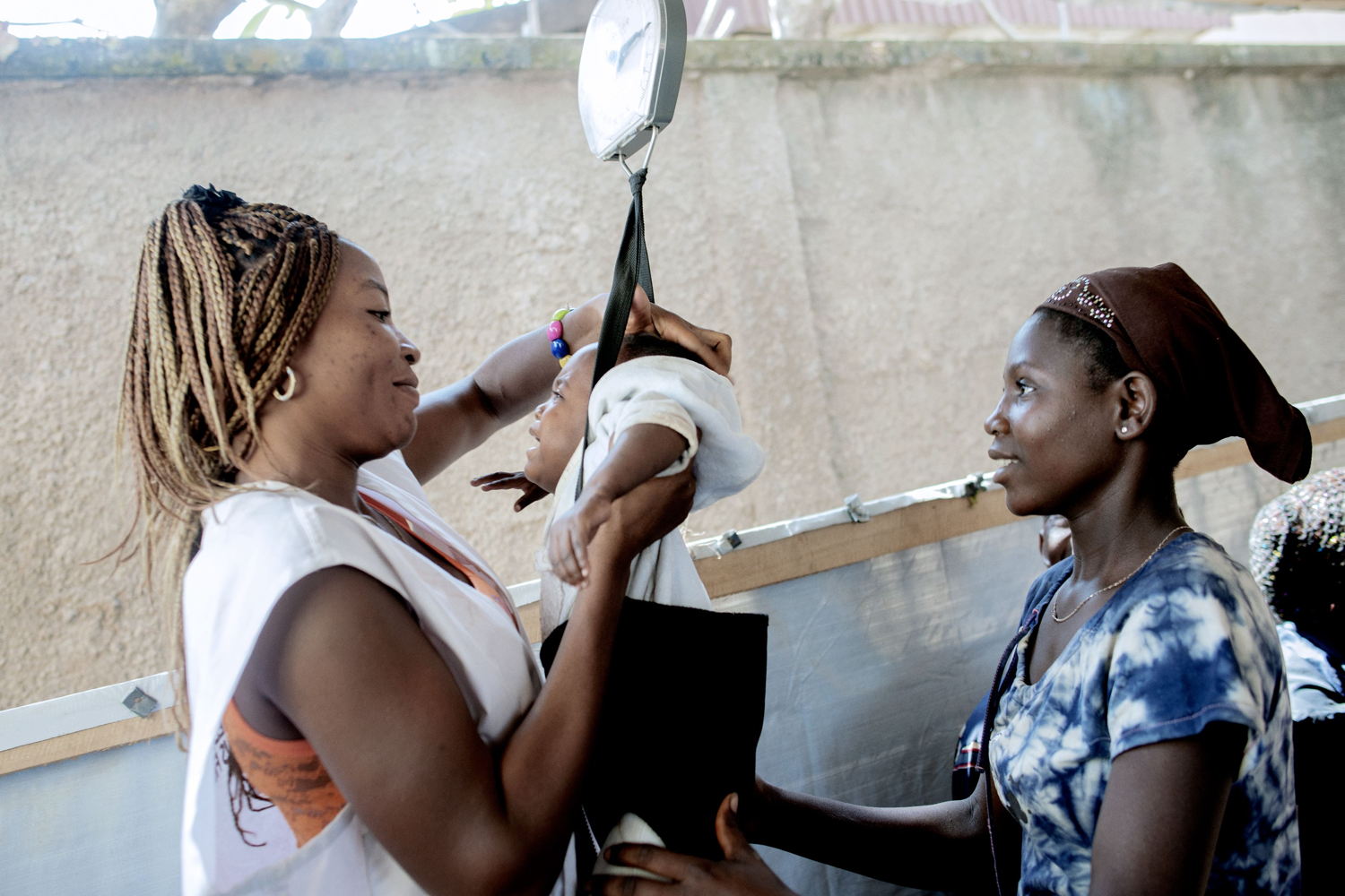 17 year old Mireil has her baby weighed by a Medecins Sans Frontiers (MSF) staff member at an MSF hospital at a displaced persons camp in Benzvi, Bangui.