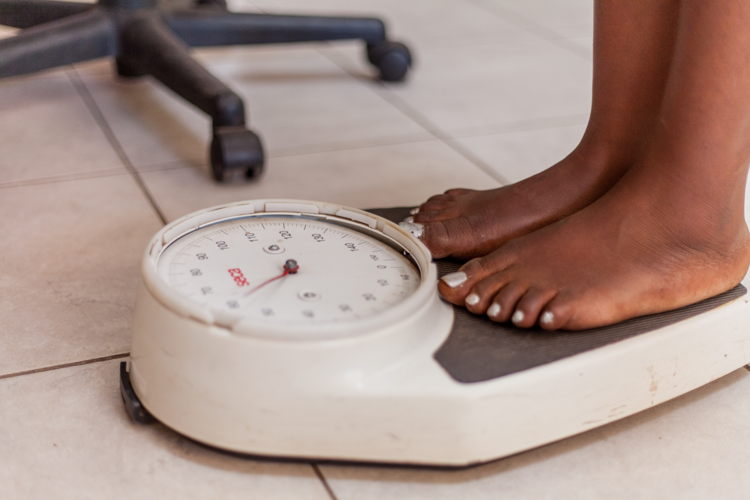 Tapiwa stands on the scale as her weight needs to be documented with her Medical affidavit. Photographer: Charmaine Chitate Tapiwa stands on the scale as her weight needs to be documented with her Medical affidavit. Photographer: Charmaine Chitate