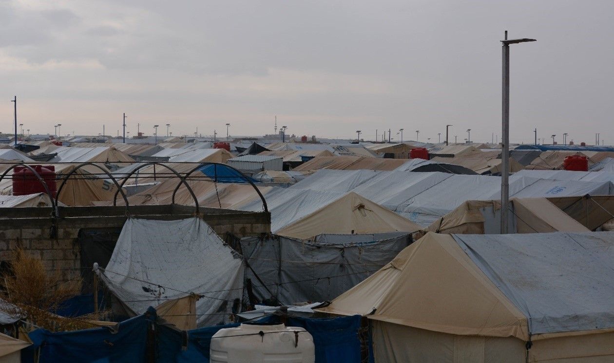 A small pond of muddy, stagnant water between two tents after heavy rains, Al-Hol camp, northeast Syria, 13/12/2023.