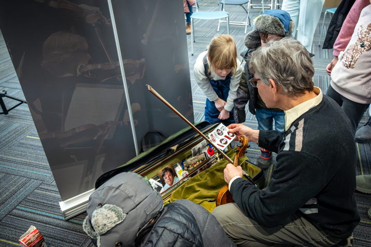 Kids explore TSO Violin James Wallenberg's violin case at a Symphony Storytime.. January 19, 2024. (Photo by Allan Cabral/Courtesy of the Toronto Symphony Orchestra)