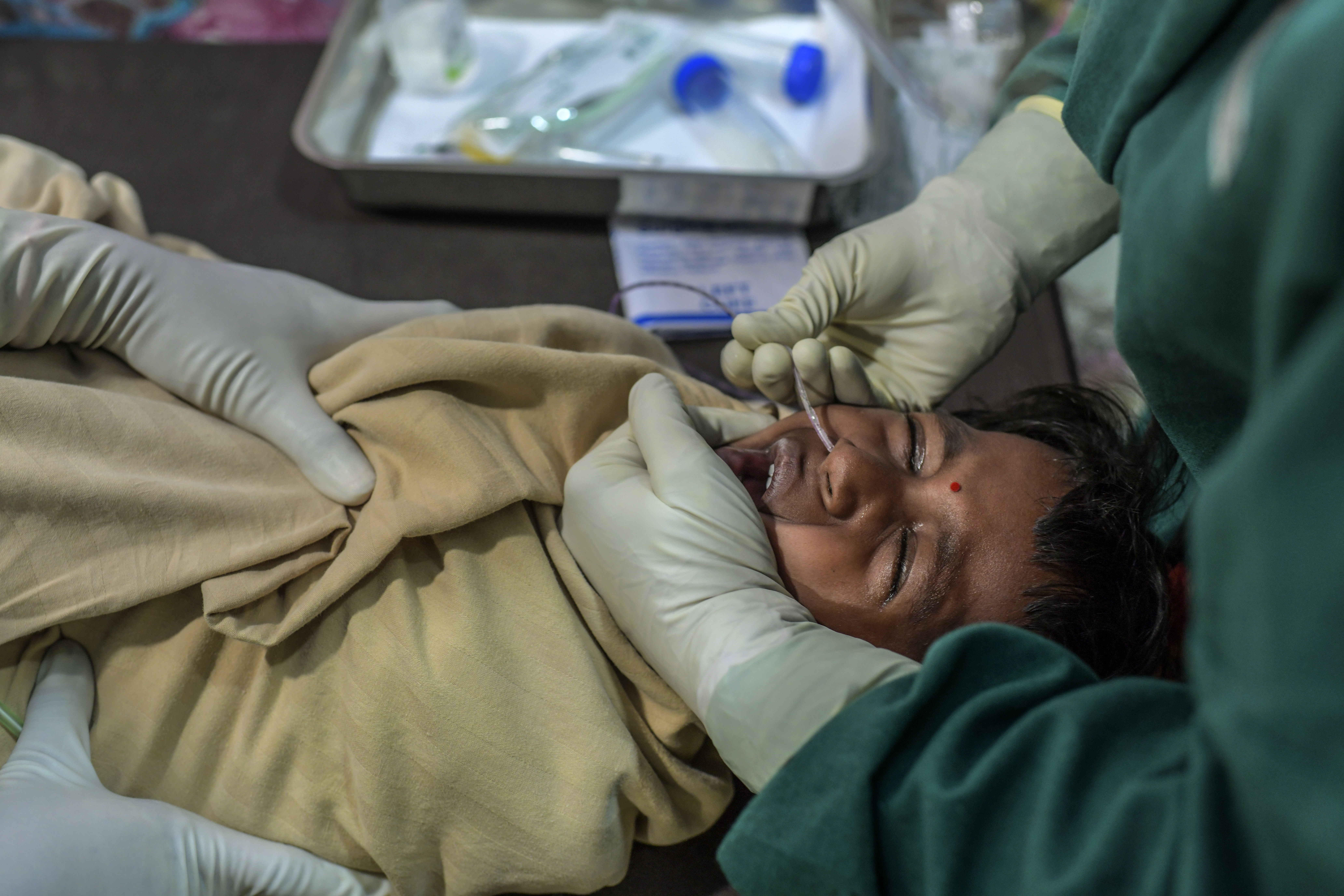 MSF Nurse inserting appropriate -sized Nasogastric tube (NG) tube to extract samples for TB diagnosis, at MSF independent Clinic, Mumbai- India. Copyright: Atul Loke/MSF