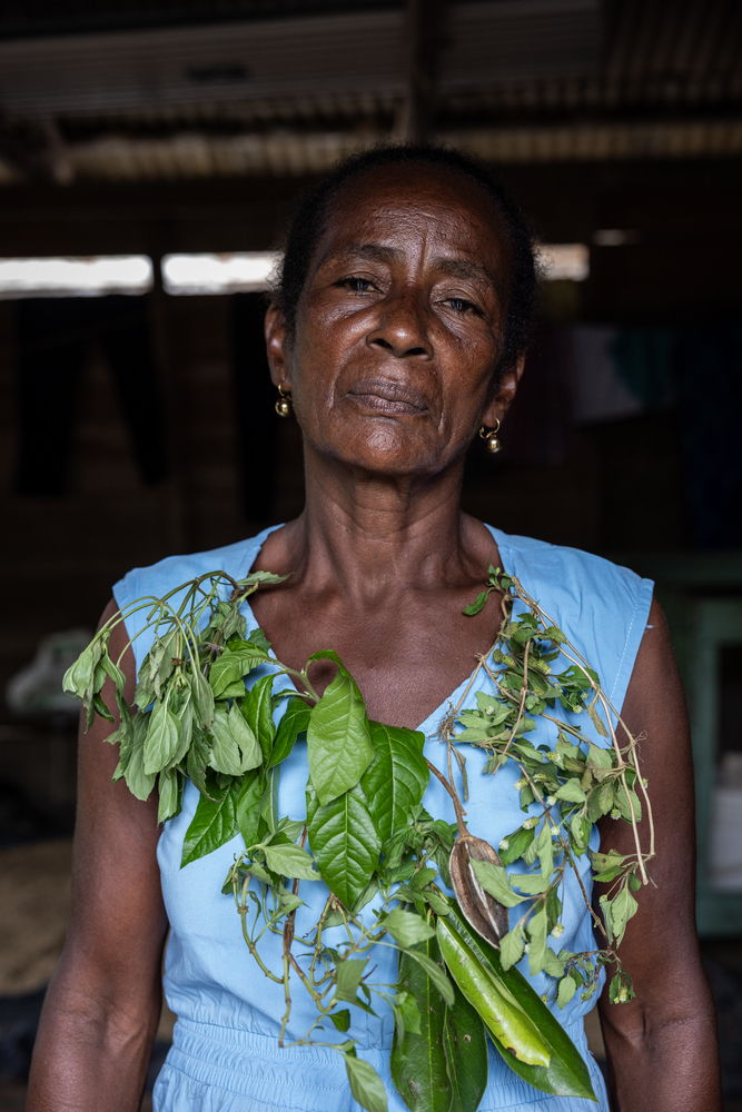 Traditional healer Margarita Rojas Mena, from the community of Mojaudó, Alto Baudó, Chocó. In Riverographies of Baudó, seven healers and midwives symbolically healed the wounds of their territory. Each woman healer tore an image of the place she wanted to heal and then, in the same way she has kept her community healthy, applied herbs and sutures.