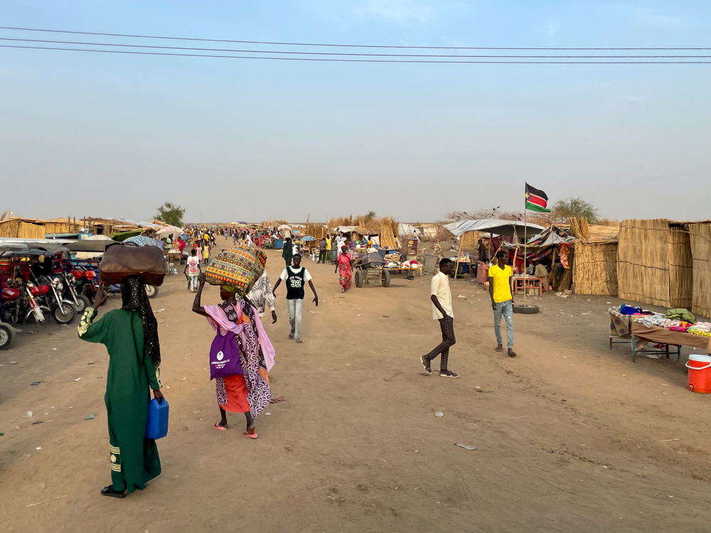 View of people walking along the Transit Centre. Kristen Poels/MSF 