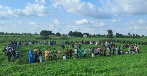 Dr Angarawai explaining the forage crop experimental plot to the students and staff from the Faculty of Agriculture, Department of Vocational and Technical Education, Ahmadu Bello University, Zaria