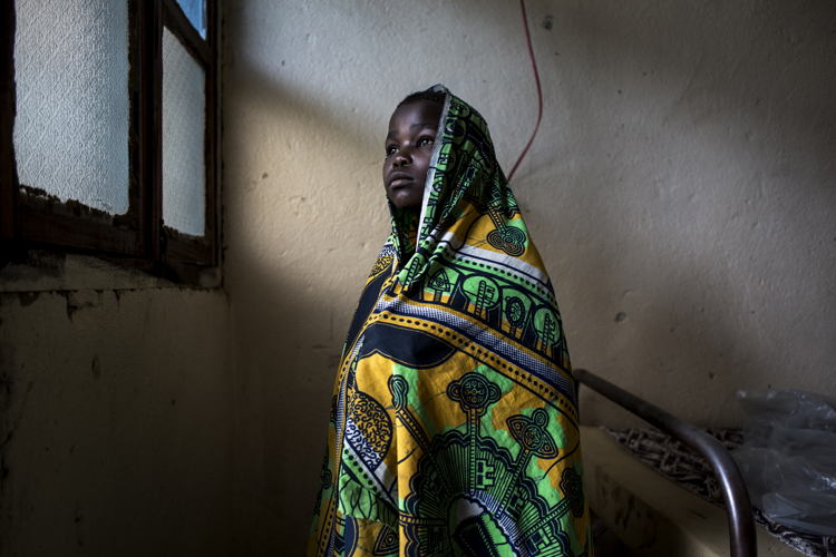 Paulette Buye (12), recovers in a hospital room on 2 March 2018 in Bunia. An attack on her village led to her being struck in the back of the neck with a machete, and she, her mother and her brother, who suffered a machete wound to the leg, hide in the bush for three nights before making the trip to Bunia to find help. ©John Wessels/MSF Paulette Buye (12), recovers in a hospital room on 2 March 2018 in Bunia. An attack on her village led to her being struck in the back of the neck with a machete, and she, her mother and her brother, who suffered a machete wound to the leg, hide in the bush for three nights before making the trip to Bunia to find help. ©John Wessels/MSF