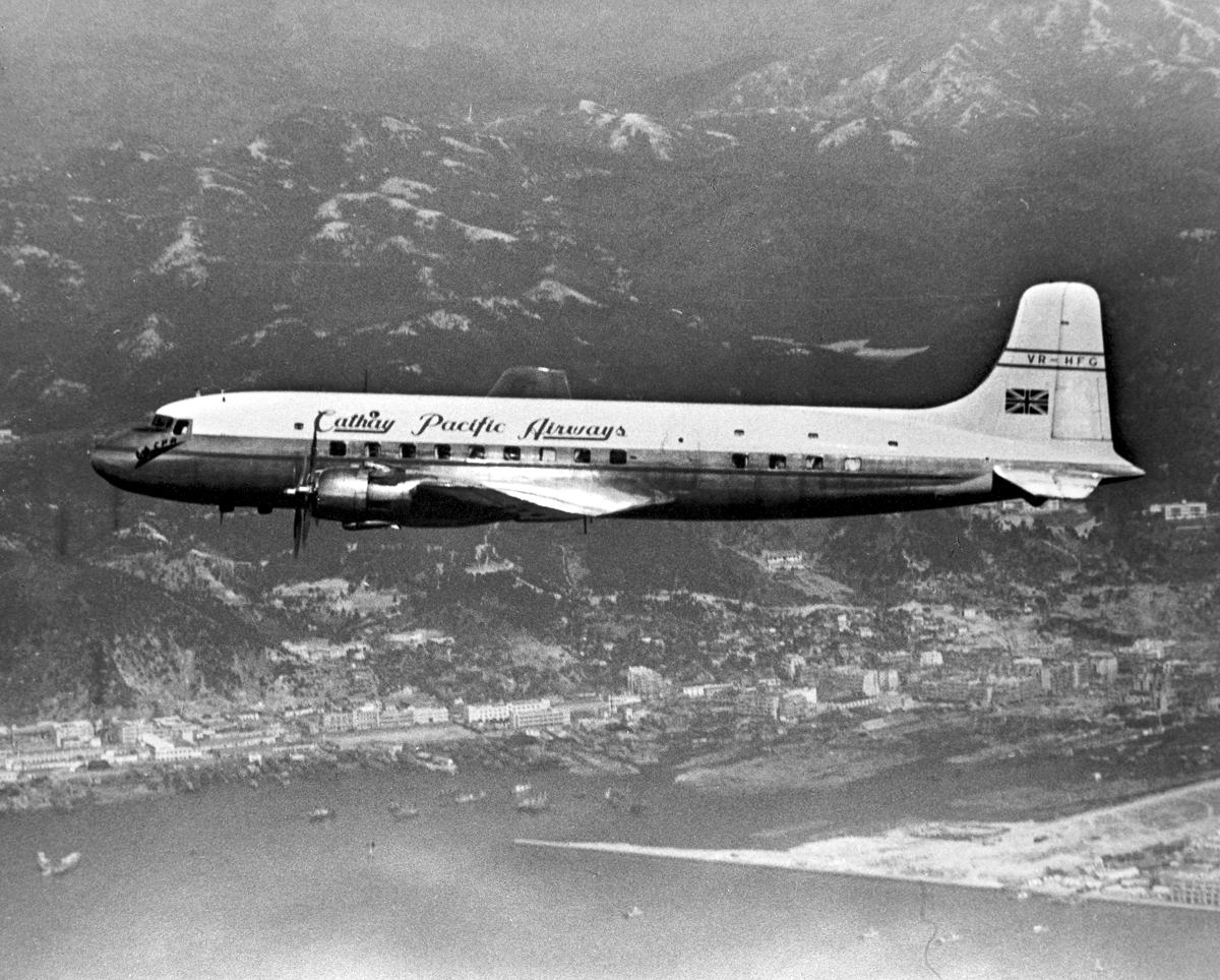 A DC-6 flying over Hong Kong, 1957. Cathay Pacific inaugurated its non-stop Hong Kong–Singapore service in 1955 with the DC-6 aircraft. (Photo: Swire Archives)