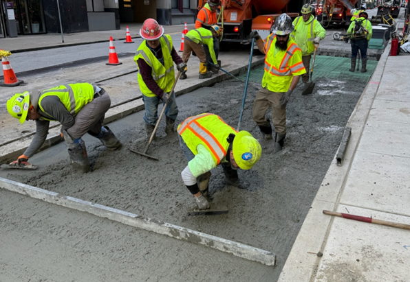 Crews placing new concrete roadway at Forbes Avenue and McKee Place