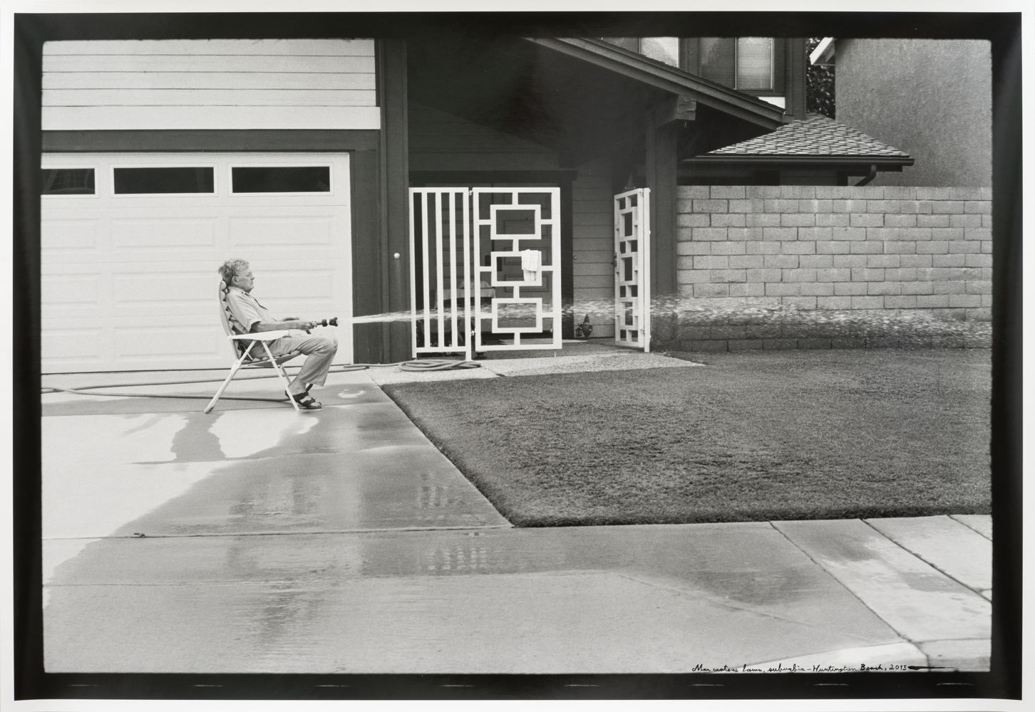 ED TEMPLETON Man waters Lawn, Suburbia, Huntington Beach, 2013 - 2024 photograph, ink 68 x 98 cm edition of 3 and 1 A.P. Courtesy Tim Van Laere Gallery, Antwerp-Rome