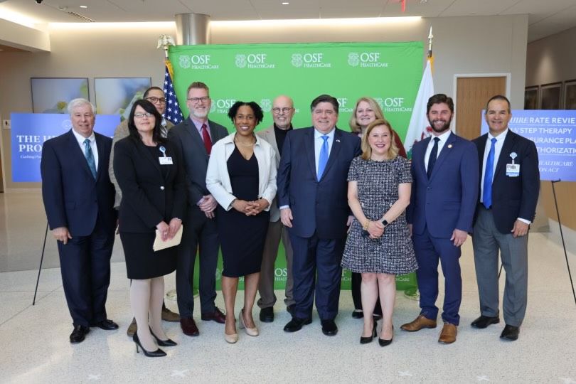Governor Pritzker and Lt. Governor Stratton pose with HPA Advocates.