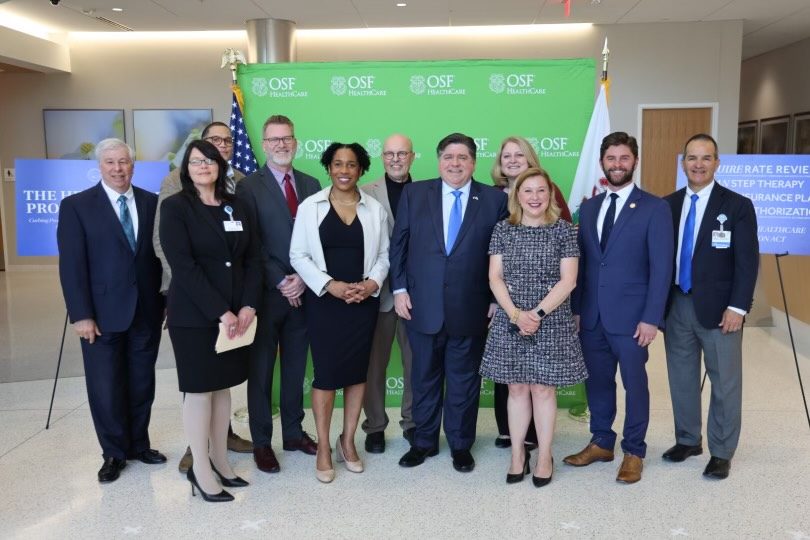 Governor Pritzker and Lt. Governor Stratton pose with HPA Advocates.