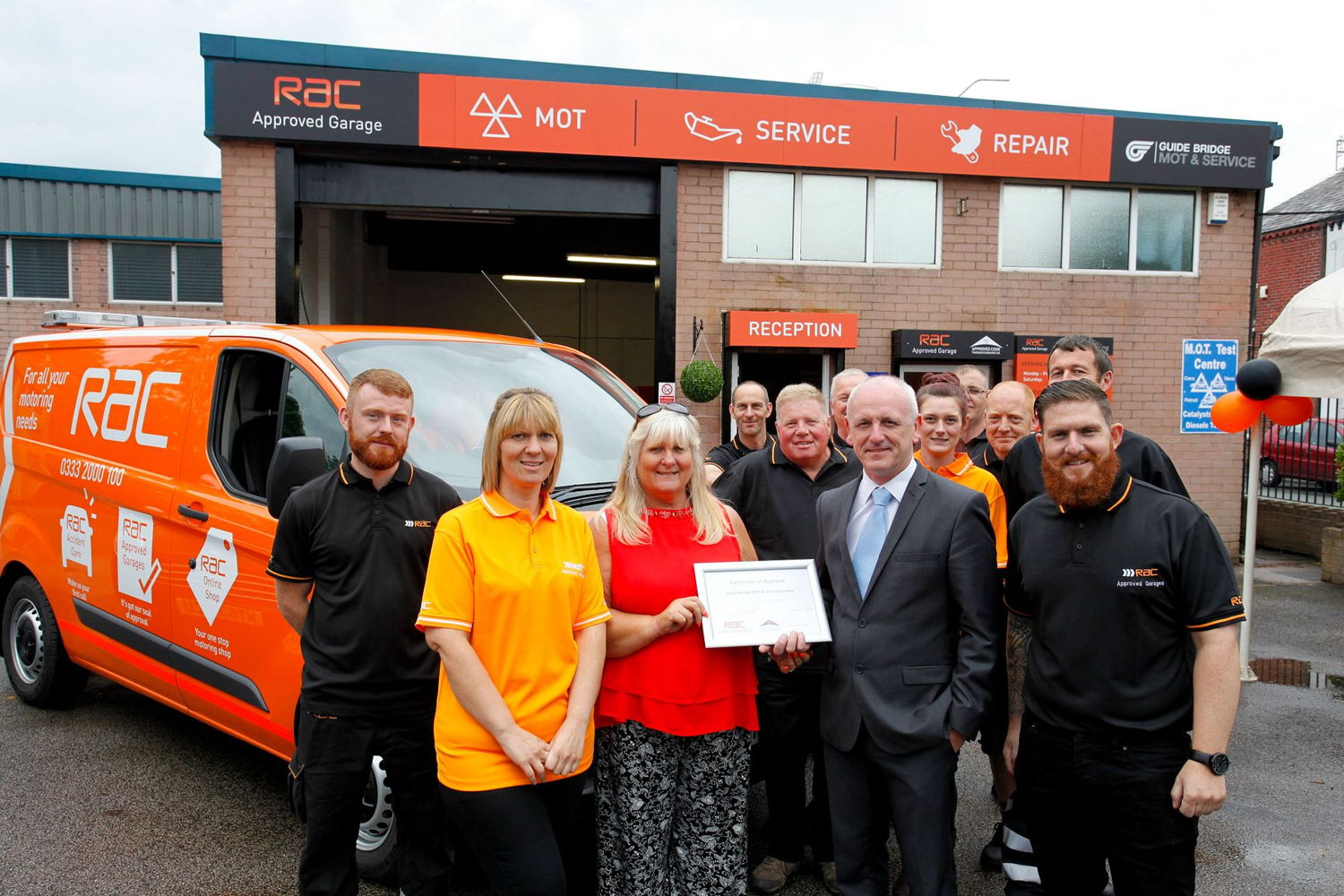 Guide Bridge MOT and Service, an RAC Approved Garage (Jan Lord and staff at Guide Bridge MOT and Service in Ashton-under-Lyne receive recognition from the RAC's Gary Wrightson-Heyworth for their work in opening their newly-branded RAC Approved Garage)