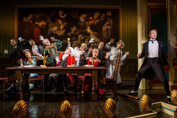 National Touring Company. The cast with James Taylor Odom as Lord Adalbert D’Ysquith (red) and Blake Price (far right) as Monty Navarro in a scene from “A Gentleman’s Guide to Love & Murder.” Photo credit: Joan Marcus. 