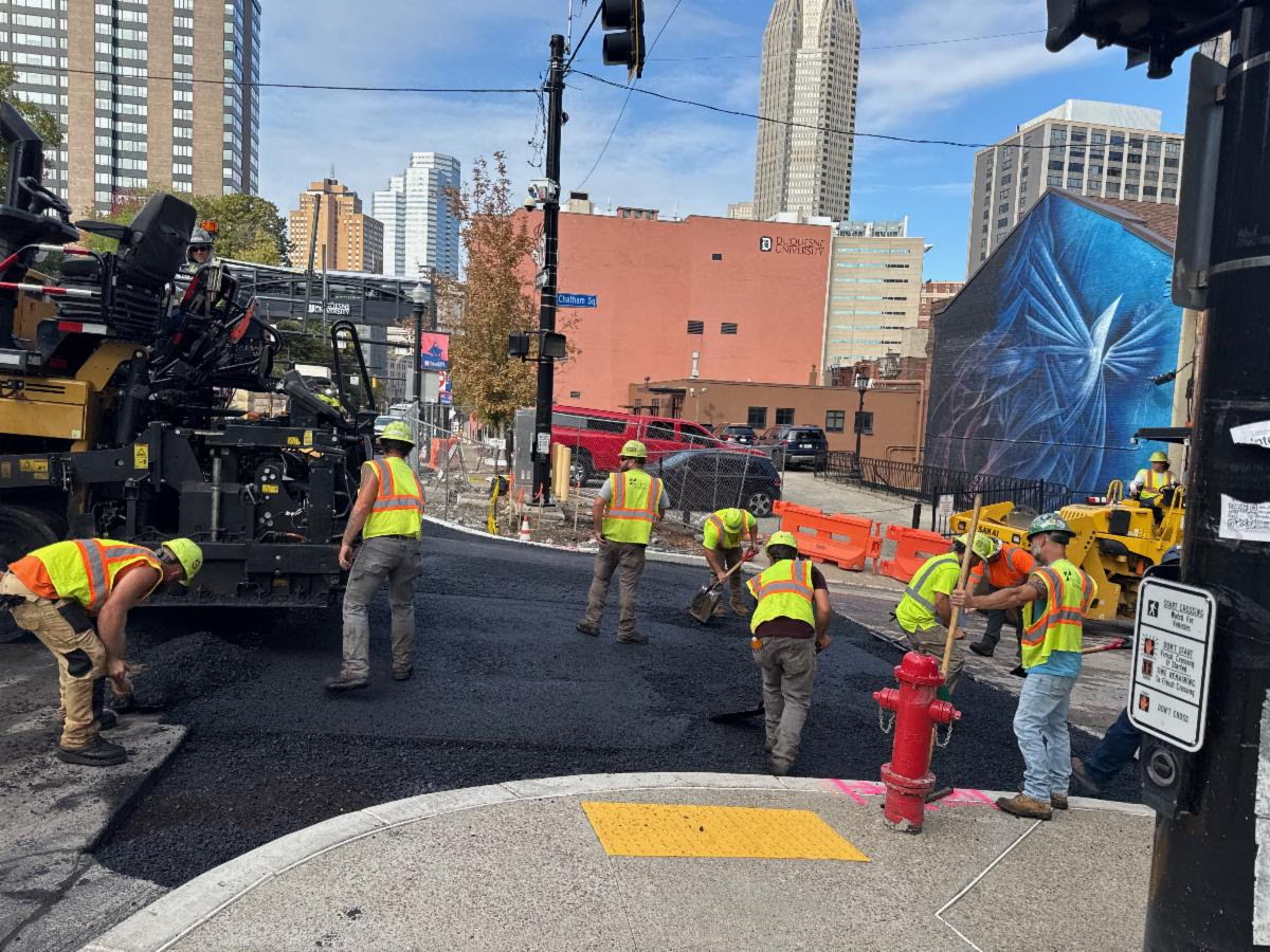 Crews pave the intersection on Forbes Avenue at Chatham Square