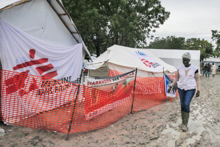 MSF Nurse Supervisor in Bulukat Emergency Project Apayi Dawa walks in front of MSF’s Mobile Clinic in Bulukat, Upper Nile State in South Sudan. The Bulukat transit camp has turned muddy following the rain, increasing health access challenges and risk of water borne diseases for the thousands of people fleeing the conflict in Sudan. Photographer: Gale Julius Dada | Location: South Sudan | Date: 16/08/2023 MSF Nurse Supervisor in Bulukat Emergency Project Apayi Dawa walks in front of MSF’s Mobile Clinic in Bulukat, Upper Nile State in South Sudan. The Bulukat transit camp has turned muddy following the rain, increasing health access challenges and risk of water borne diseases for the thousands of people fleeing the conflict in Sudan. Photographer: Gale Julius Dada | Location: South Sudan | Date: 16/08/2023