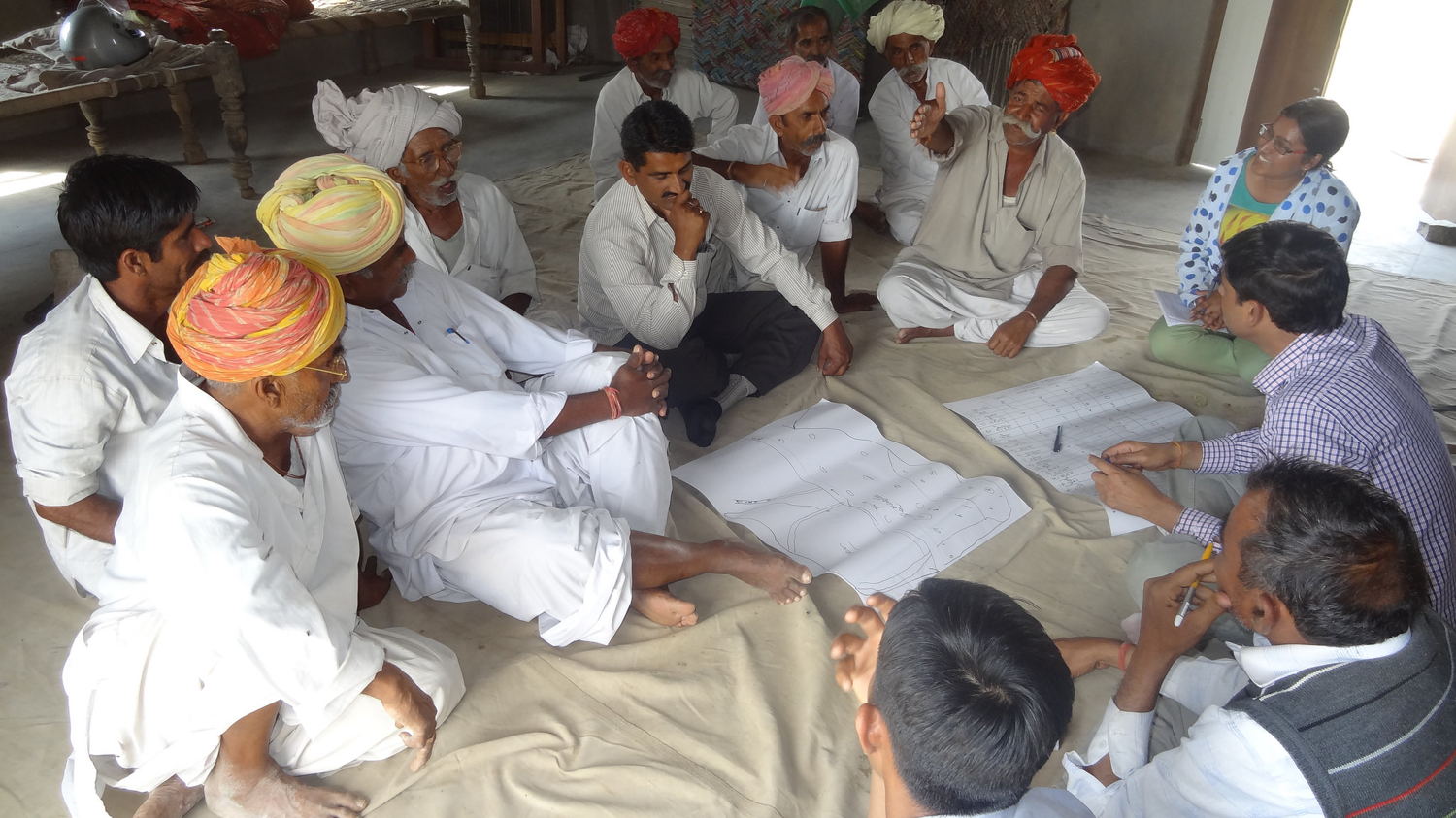  Farmers engaged in a discussion as they eagerly wait for the upcoming cropping season.