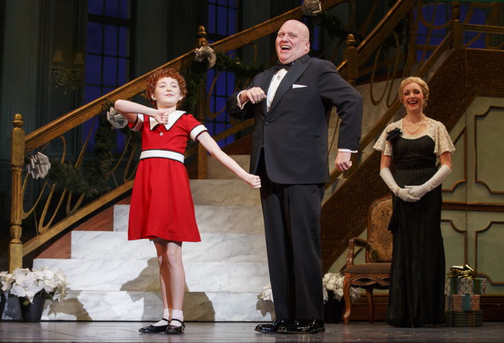Heidi Gray as Annie, Gilgamesh Taggett as Oliver Warbucks and Chloe Tiso as
Grace Farrell in “I Don’t Need Anything but You”
Photo: Joan Marcus