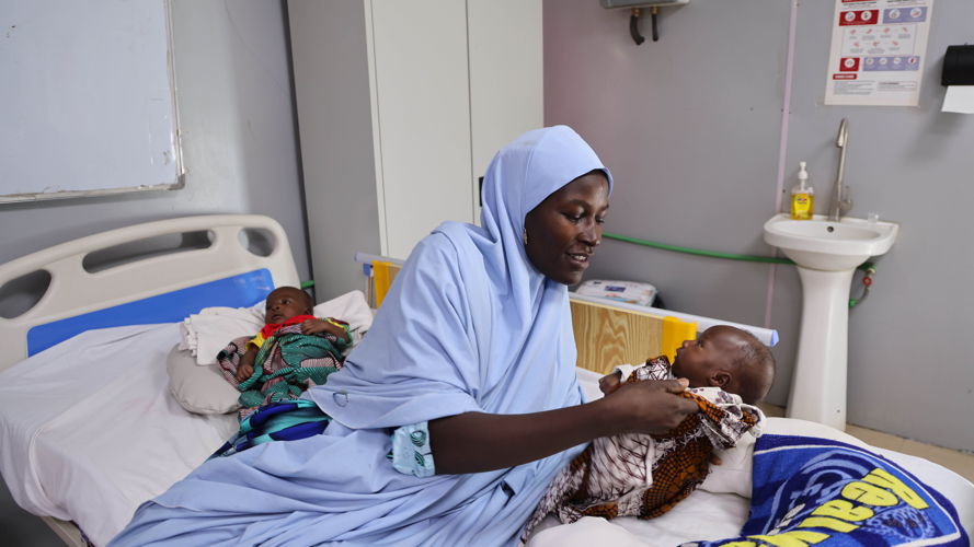 Zarah Babagana looks on as MSF nurses attend to her five-month old twins, Fatima and Ali, who are being treated for malnutrition at the under-six ward of the MSF-run Nilefa Kiji nutrition centre in Maiduguri, Nigeria. The under-six ward is where children under the age of six months that have malnutrition and other medical complications are admitted and treated. Zarah and her husband, Babagana Mala who live in Maiduguri, the Borno state capital, were displaced from Ngala, a town located in eastern part of Borno state, Nigeria due the insurgency in the region. Copyright MSF
