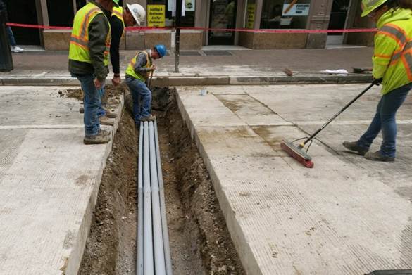 PRT electrical subcontractors placing conduit across Liberty Avenue