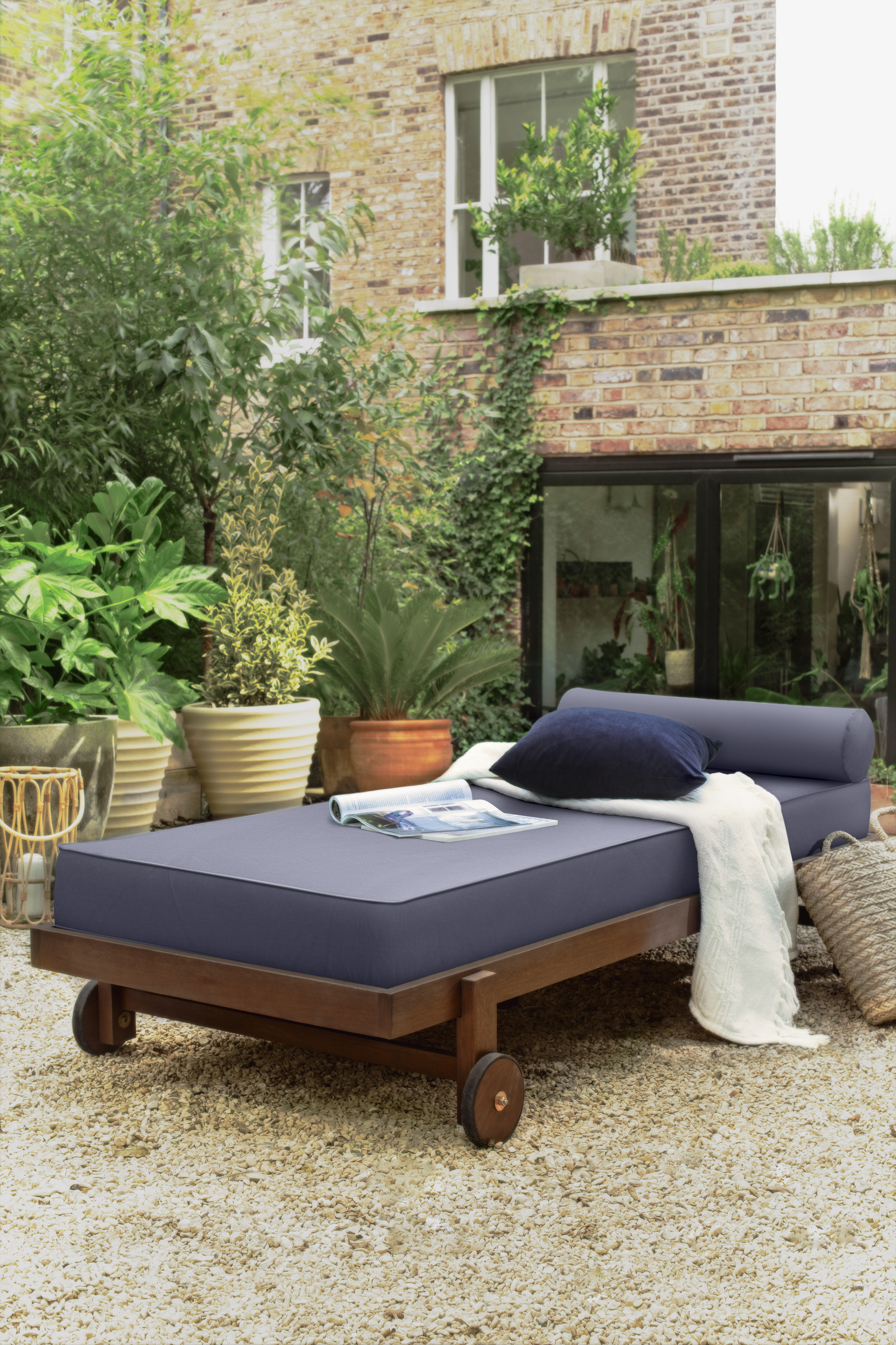 Day Bed, £275; Cushion, £6.50; Bamboo Lantern, £30; Plaited Basket, £14; Moroccan Planters, £28