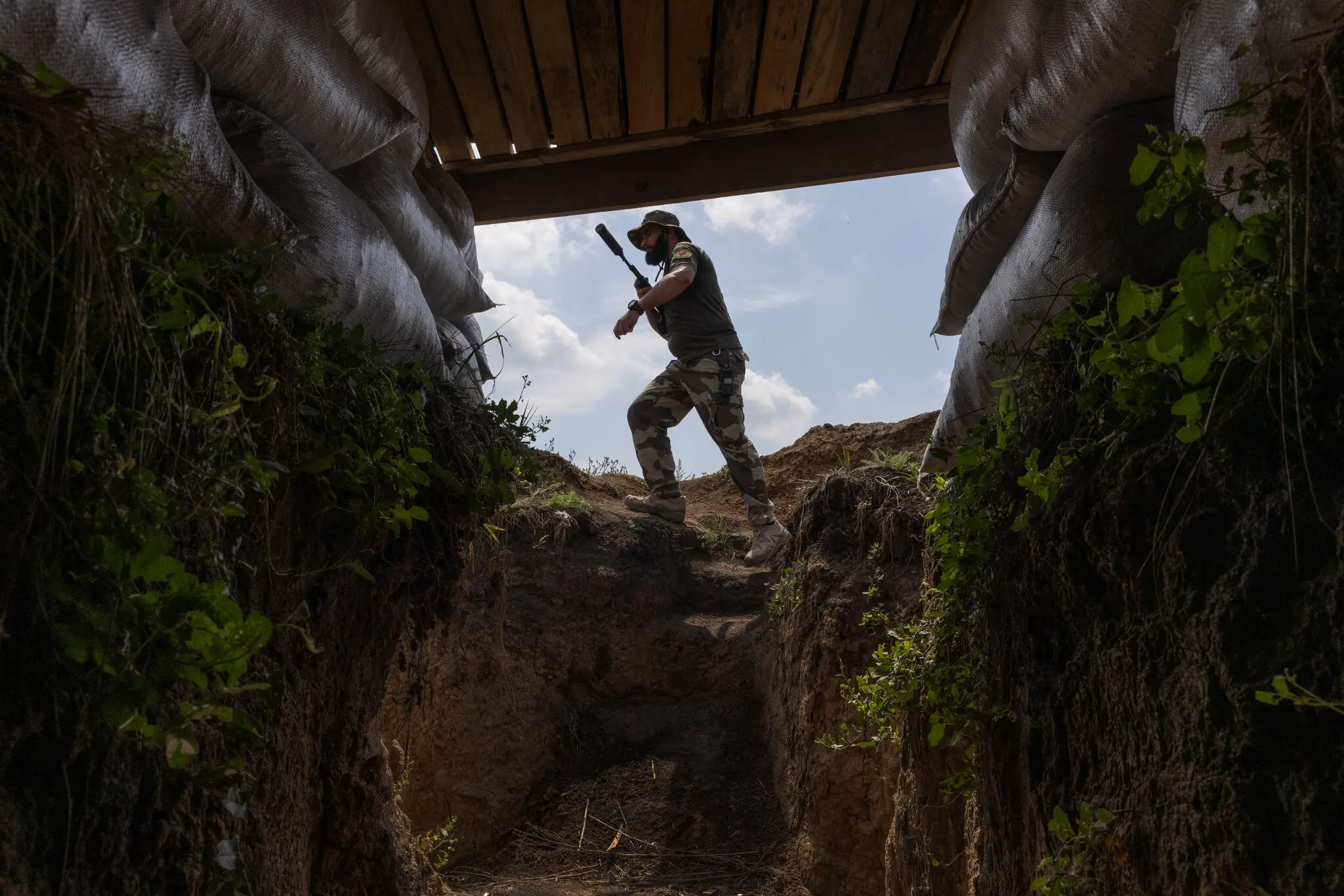 A fighter with Dnipro-1, a unit in Ukraine’s National Guard, walking through an underground bunker along the frontline outside Sloviansk, Ukraine, on Aug. 3. David Guttenfelder, The New York Times 