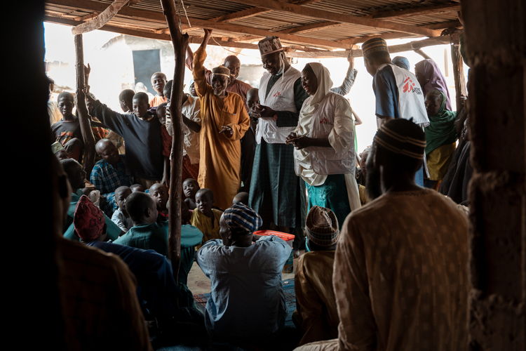 Maryam Muhammad and the MSF health promotion team conduct a Tom Brown sensitization session for men in Kebbi. Convincing men to support the approach is key as the mostly are the one supplying the family. For cultural reasons, MSF organizes separated sessions for men and women | Date taken: 01/02/2024 | Photographer: Georg Gassauer | Location: Nigeria