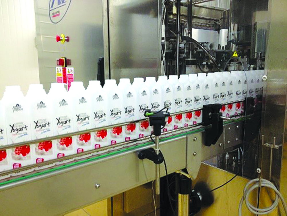 Jebsen & Jessen Packaging bottles on Farm Fresh’s filling line.