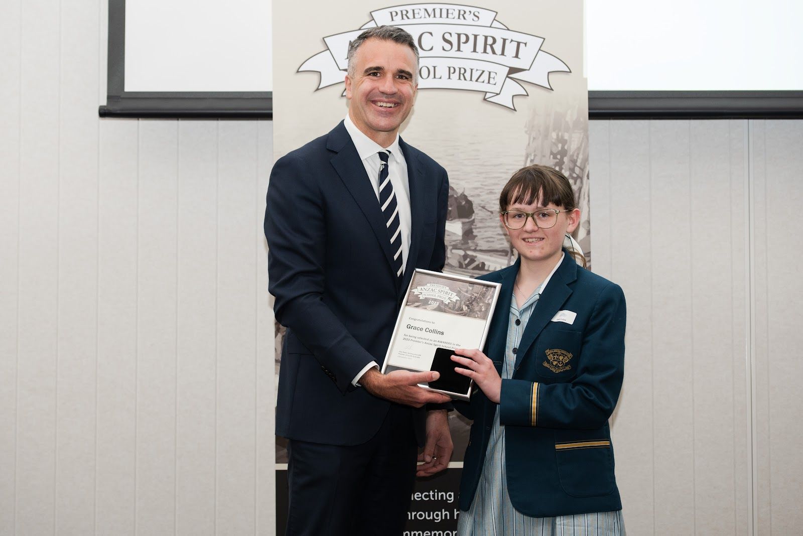 Premier Peter Malinauskas presents Grace Collins with the Premier's ANZAC Spirit School Prize