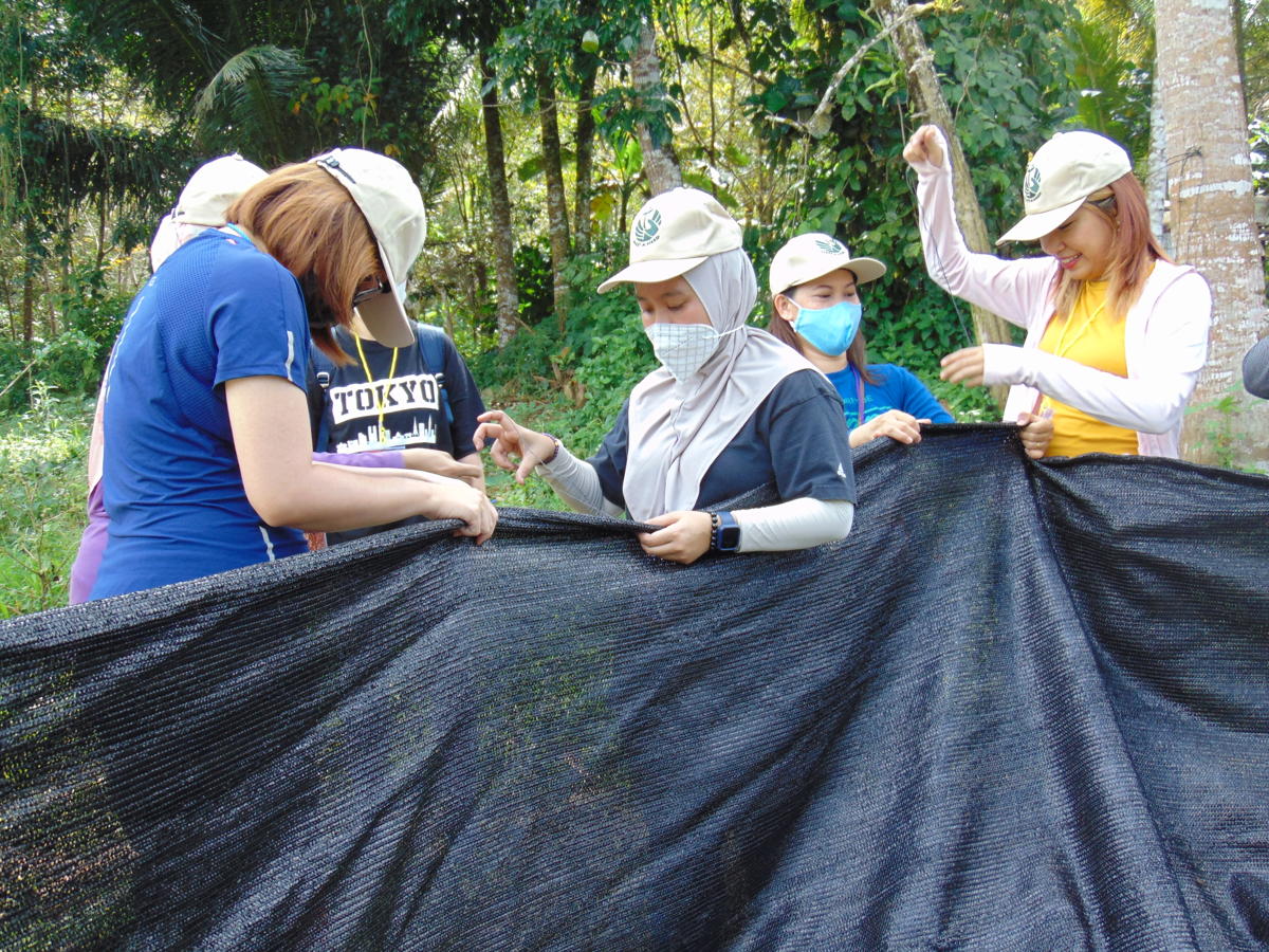 Meet a Need volunteers sewing shade cloths.