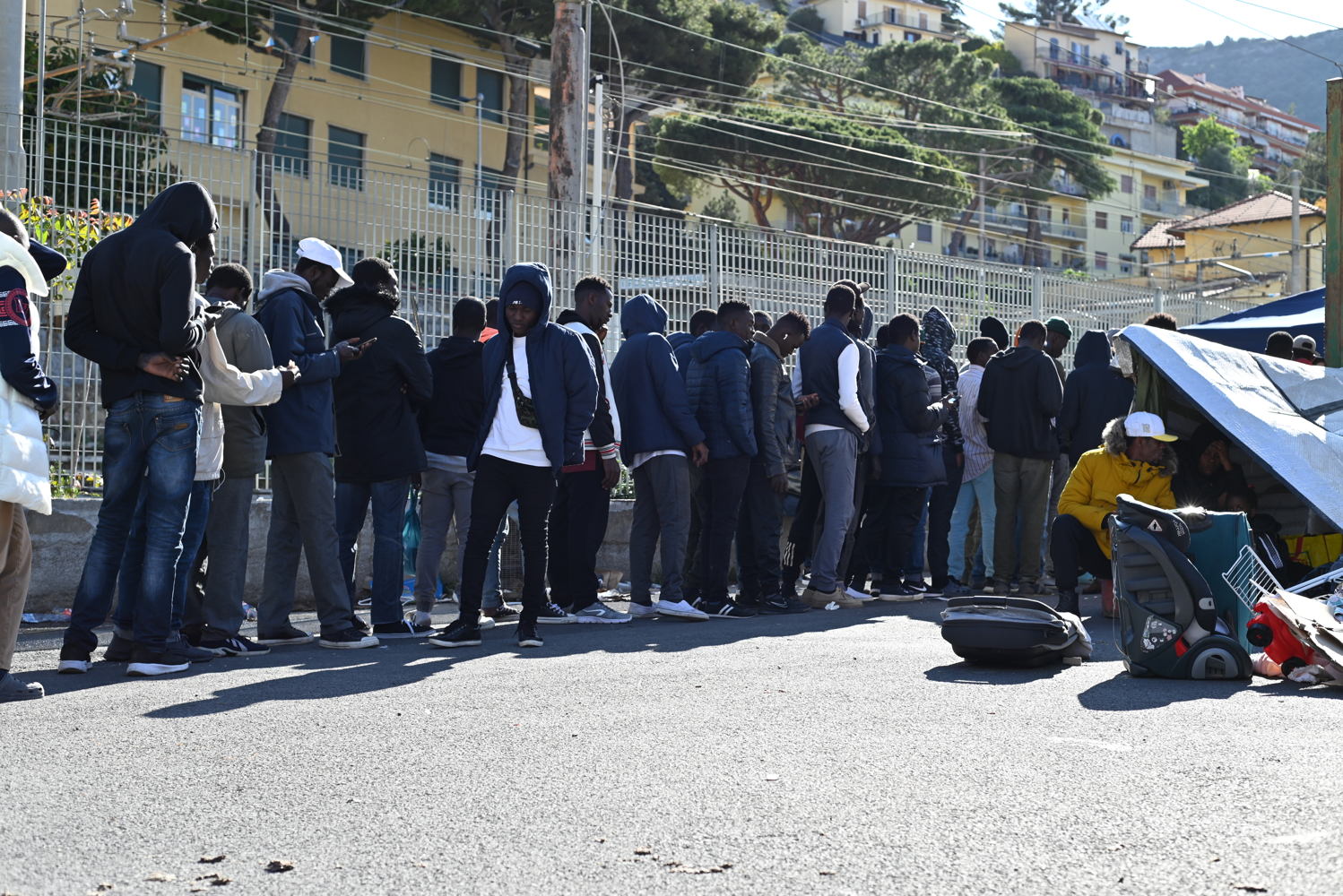 Title: Persons in transit in Ventimiglia Copyright: MSF/Candida Lobes Countries: Italy Date taken / Date Recorded: 15 May, 2023 Caption / Description: Hundreds of migrants attempt to access France from the Italian border town of Ventimiglia. Since 2015, French authorities have implemented border controls and movement restrictions for people in transit. As a result, indiscriminate pushbacks had become more common, including for unaccompanied minors and vulnerable people. Most persons in transit find temporary shelter in the streets of Ventimiglia, living in extremely harsh and unhealthy conditions before attempting to cross the border again, left with no services nor assistance.