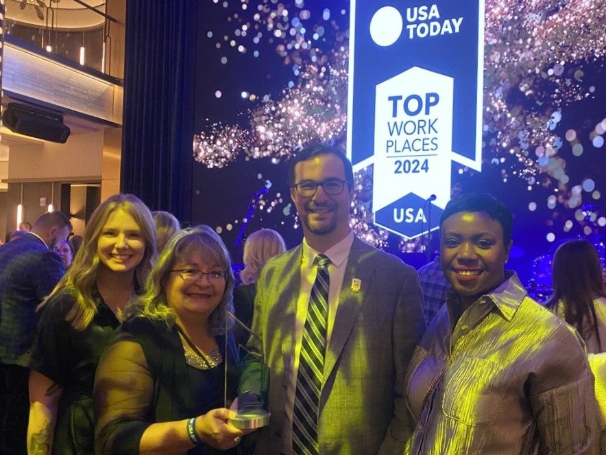 Wellby Financial team members at the USA TODAY award ceremony (show from left to right): Kate Burkett, Manager of Marketing and Communications; Deborah Conder, Chair of Board of Directors; Marty Pell, President & CEO; and Alexis Lewis, Chief Legal Officer.