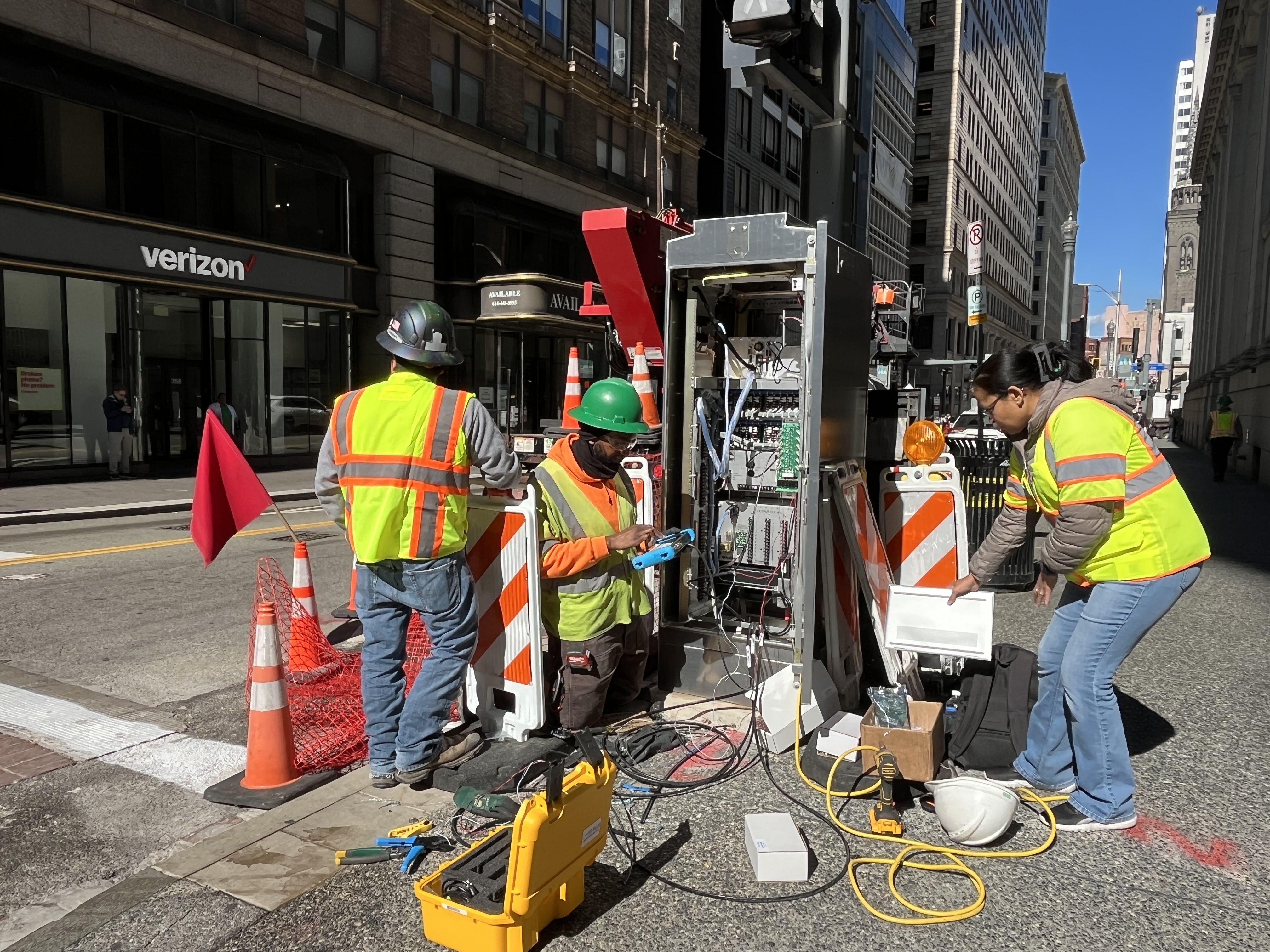 Electrical crew activating new traffic signals on Fifth Avenue at Smithfield Street