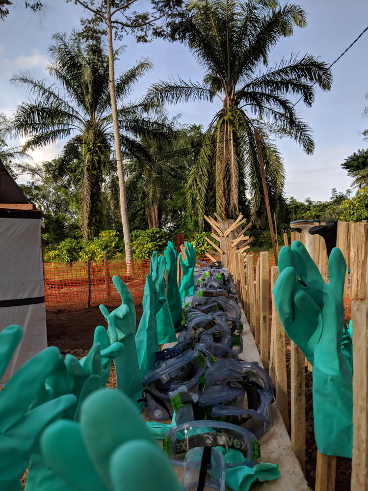Ski goggles, gloves and coconut trees: this is Ebola. Glasses and gloves are part of the security dressing (PPE) to enter the area at risk). They are decontaminated after each exit of the staff and put to dry. Photographer: Karin Huster/MSF