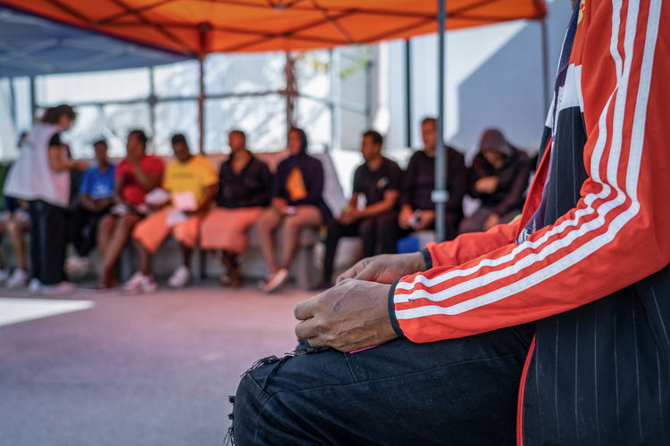 Medium shot of a patient’s hands waiting outside MSF’s mobile clinic in the Closed Control Access Centre in Zervou, Samos. Since April 2022, MSF has started to provide primary healthcare services (including sexual and reproductive health care) inside the closed access and control center of Zervou. An MSF health promoters team makes sure that people in the camp are aware of the kind of support MSF can provide. Photographer: Evgenia Chorou/MSF| Location: Zervou, Samos, Greece | Date: 29/09/2022 Medium shot of a patient’s hands waiting outside MSF’s mobile clinic in the Closed Control Access Centre in Zervou, Samos. Since April 2022, MSF has started to provide primary healthcare services (including sexual and reproductive health care) inside the closed access and control center of Zervou. An MSF health promoters team makes sure that people in the camp are aware of the kind of support MSF can provide. Photographer: Evgenia Chorou/MSF| Location: Zervou, Samos, Greece | Date: 29/09/2022