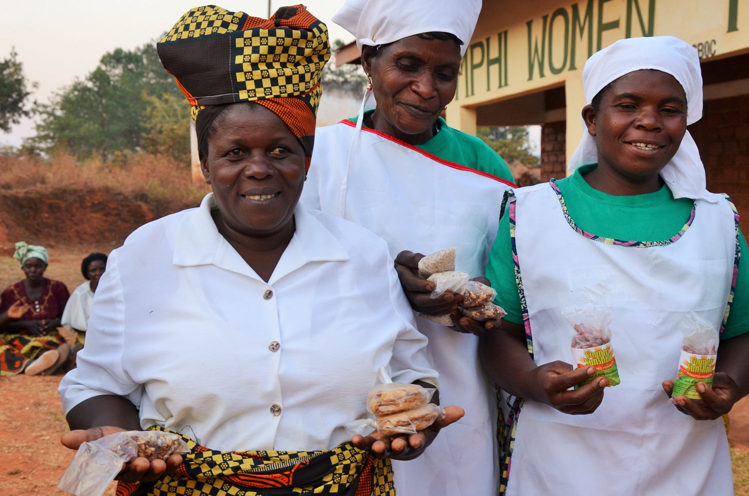 Women farmers showcasing their crop products.