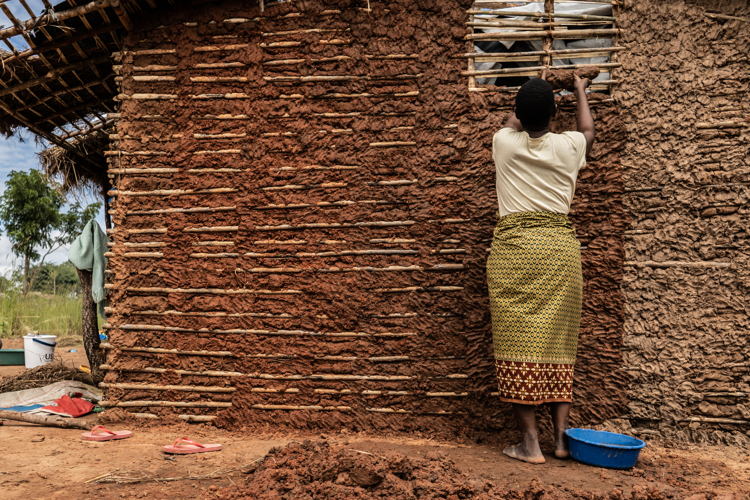 
Cabo Delgado: Mapupulo IDP site
At the Mapupulu site for internally displaced persons a woman is seen patting mud into the frame of the hut her family is building after having fled the armed conflict happening in Northern Mozambique, Cabo Delgado province. Photographer: Tadeu Andre