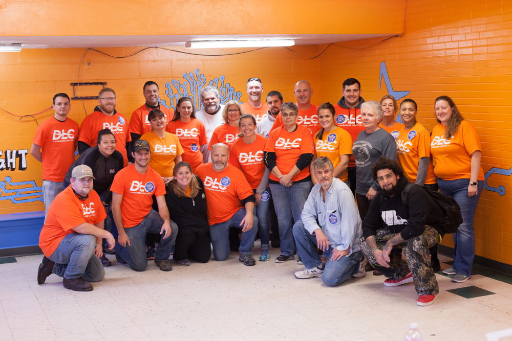 Bringing fresh color to the Shadyside Boys & Girls Club, employee volunteers helped to paint a STEM-themed mural.