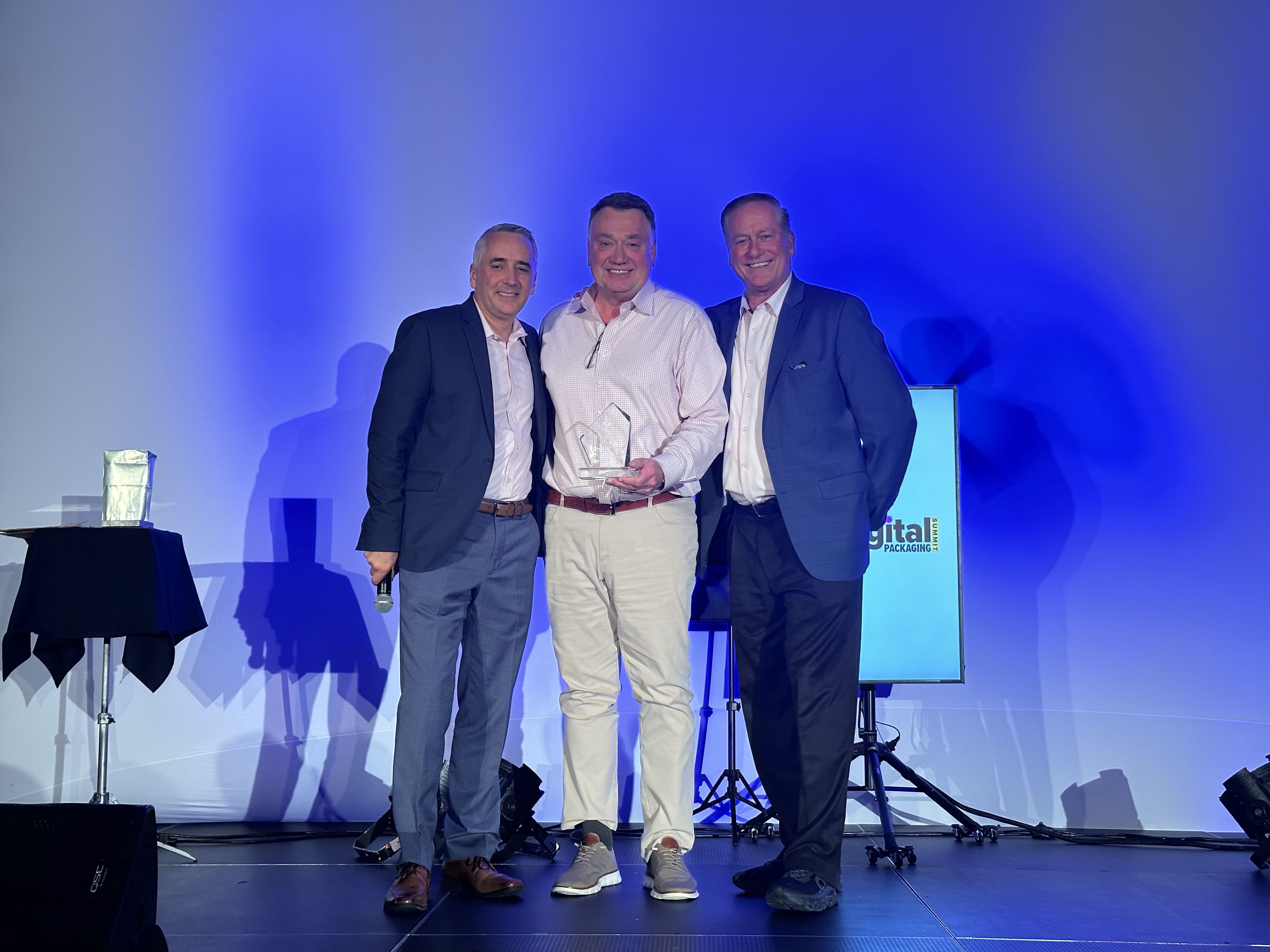 IMAGE CAPTION: Ken Brown, BOBST Product Business Development Manager (center), receiving the award from Event Director David Pesko (L) and Chris Lyons (R).