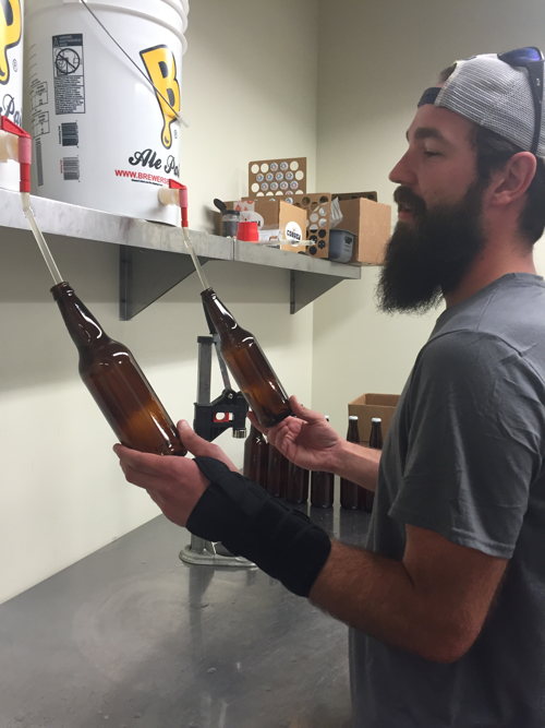 William Brant of CO-Brew fills sanitized bottles with the cantaloupe gose